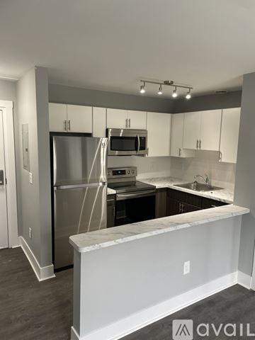 Highland Park apartment for rent - A kitchen with a white counter and stainless steel appliances.