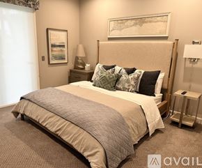 Nokomis house for rent - A bedroom with a large bed and a painting on the wall.
