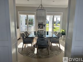 Nokomis house for rent - A dining room with a glass table and chairs.
