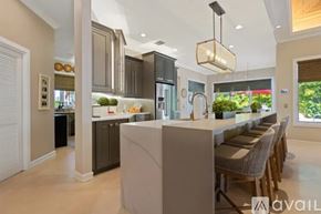 Nokomis house for rent - A modern kitchen with a large island and a dining area.