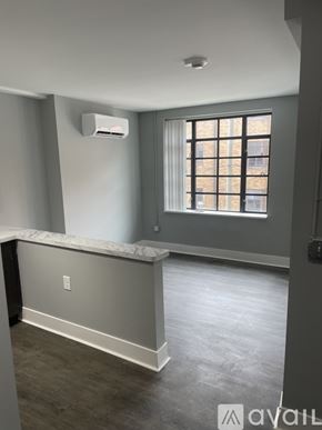 Highland Park apartment for rent - A room with a window and a wall-mounted air conditioner unit.