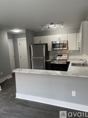 Highland Park apartment for rent - A kitchen with a marble countertop and stainless steel appliances.