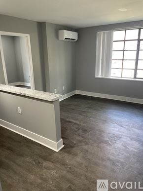 Highland Park apartment for rent - A room with a window, a mirror, and a marble countertop.
