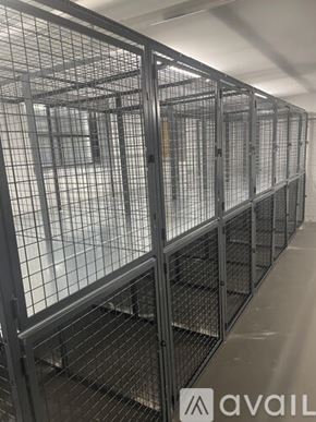 Highland Park apartment for rent - A row of metal cages are lined up in a room.