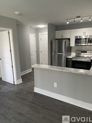 Highland Park apartment for rent - A kitchen with a refrigerator, microwave, and oven.