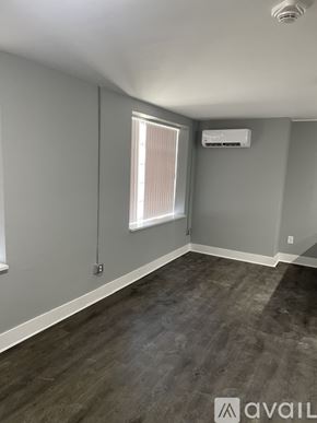 Highland Park apartment for rent - A room with a window and a wall-mounted air conditioner unit.
