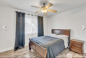 Sacramento house for rent - A bedroom with a bed, nightstand, and ceiling fan.