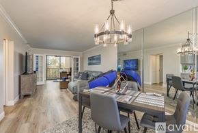 Clearwater condo for rent - A dining room with a glass table and grey chairs.