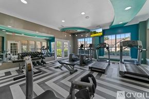 Plano apartment for rent - A gym with treadmills, elliptical machines, and dumbbells.