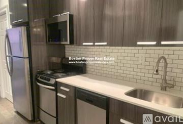 Boston apartment for rent - A kitchen with a refrigerator, microwave, dishwasher, and stove top oven.