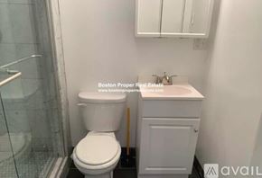 Boston apartment for rent - A white toilet and sink in a small bathroom.