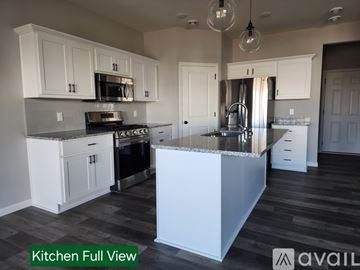 Cottage Grove house for rent - A kitchen with white cabinets and a large island.