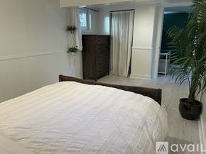Portland house for rent - A bedroom with a large bed and a wooden dresser.