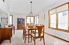 Wildwood condo for rent - A dining room with a wooden table and chairs.