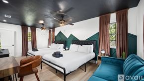 Greenville house for rent - A bedroom with a large bed and a ceiling fan.