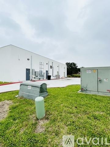 Edinburg apartment for rent - A white building with a green trash can in front of it.