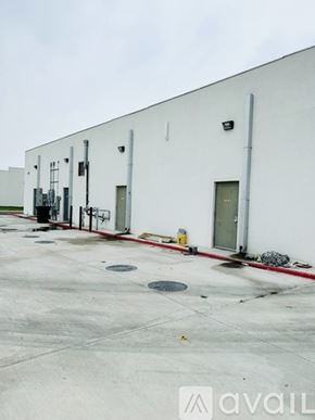 Edinburg apartment for rent - A white industrial building with a red line on the ground.