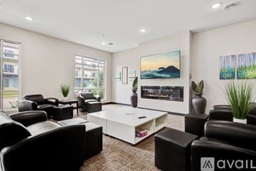 Mankato apartment for rent - A living room with black leather furniture and a large painting on the wall.
