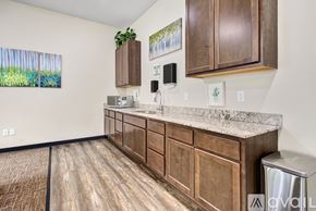 Mankato apartment for rent - A kitchen with wooden cabinets and a marble countertop.