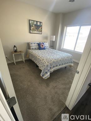 Mankato apartment for rent - A bedroom with a bed, nightstand, and window.