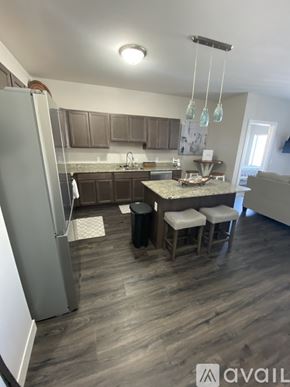 Mankato apartment for rent - A kitchen with a refrigerator, a counter, and a dining table.