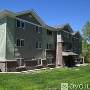 Mankato apartment for rent - A large two-story house with a balcony on the second floor.