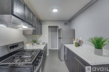 Ewing Township apartment for rent - A modern kitchen with a stainless steel refrigerator and oven.