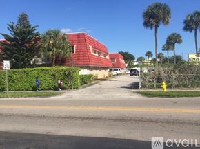 Lauderhill apartment for rent - A red building with a sign that says Kings is in the background.