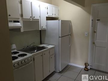 Lauderhill apartment for rent - A kitchen with white appliances and cabinets.