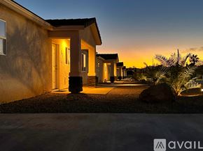 Lake Havasu City condo for rent - A house with a lit up entrance and a large rock in front of it.
