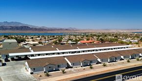 Lake Havasu City condo for rent - A bird's eye view of a residential area with houses and a road.