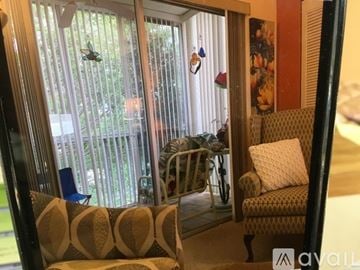 Bradenton condo for rent - A living room with a couch and a chair.