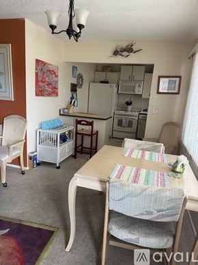 Bradenton condo for rent - A kitchen with a table and chairs in it.