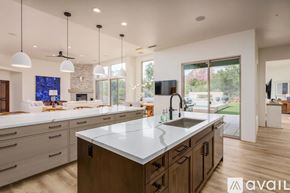 Sedona house for rent - A modern kitchen with a large island and wooden cabinets.