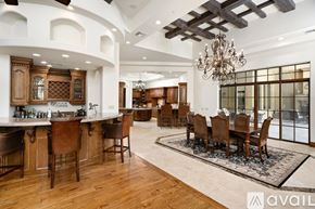 Scottsdale house for rent - A large, well-lit dining room with a wooden table and chairs.