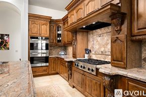 Scottsdale house for rent - A kitchen with wooden cabinets and a granite countertop.