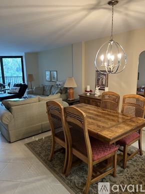 Siesta Key condo for rent - A dining room with a wooden table and chairs.