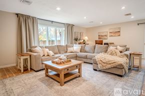 Lafayette house for rent - A living room with wooden floors and furniture.