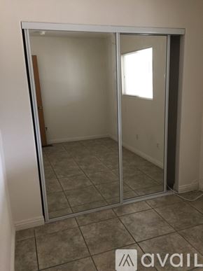 Hemet house for rent - A room with a glass door and tiled floor.