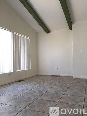 Hemet house for rent - A room with a tiled floor and a window with blinds.