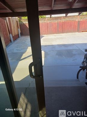 Oakland house for rent - A view from inside a building looking out to a patio with a bicycle.