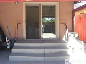 Oakland house for rent - A red wall with a glass door and a set of stairs leading to it.