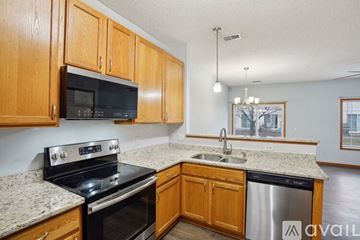 Shakopee apartment for rent - A kitchen with wooden cabinets and granite countertops.