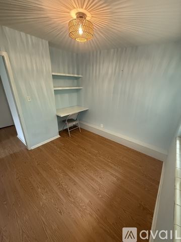 Jacksonville Beach house for rent - A kitchen with a table and chairs in the foreground and a refrigerator, oven, and microwave in the background.