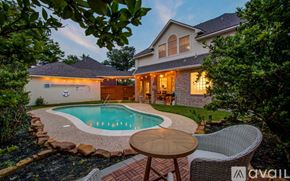 Cypress house for rent - A house with a pool in front of it.