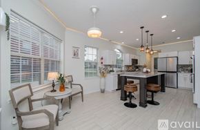 Cypress house for rent - A modern kitchen with a dining table and chairs.