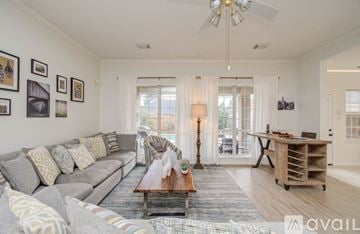Cypress house for rent - A living room with a grey sofa and a wooden coffee table.