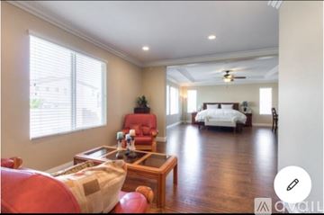 Corona apartment for rent - A living room with a red couch and a wooden coffee table.