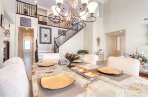 Corona apartment for rent - A dining room with a marble table and a chandelier.