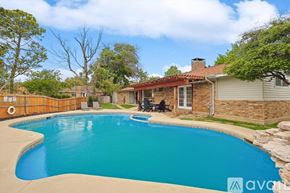 Irving house for rent - A swimming pool in a backyard with a house and trees in the background.